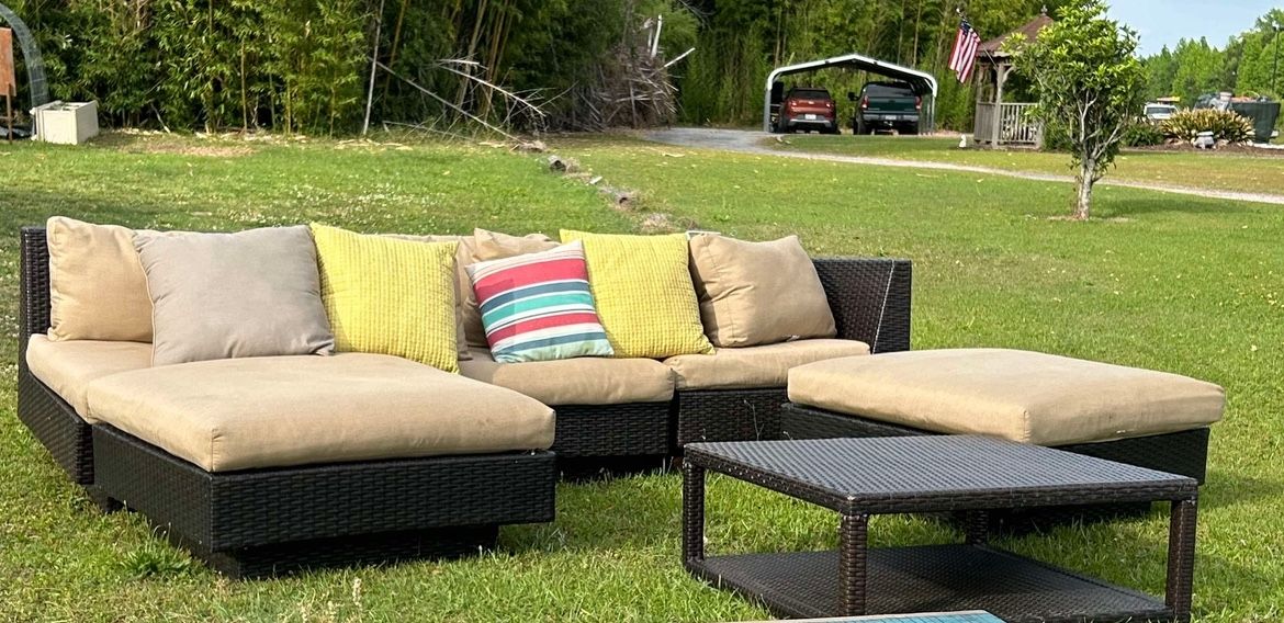 Wicker sectional patio set with table and pillows