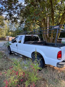 White Ford F-250 Work Truck with Ladder Rack