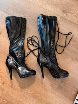 Pleaser Black Patent Knee-High Boots featuring a glossy finish, lace-up front detail, and a high stiletto heel size 6.5 halloween .