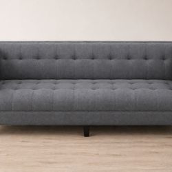 Gray tufted velvet-style sofa