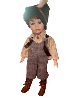Geppeddo Porcelain Boy Doll "Joshua" Overalls w/ feather hat.