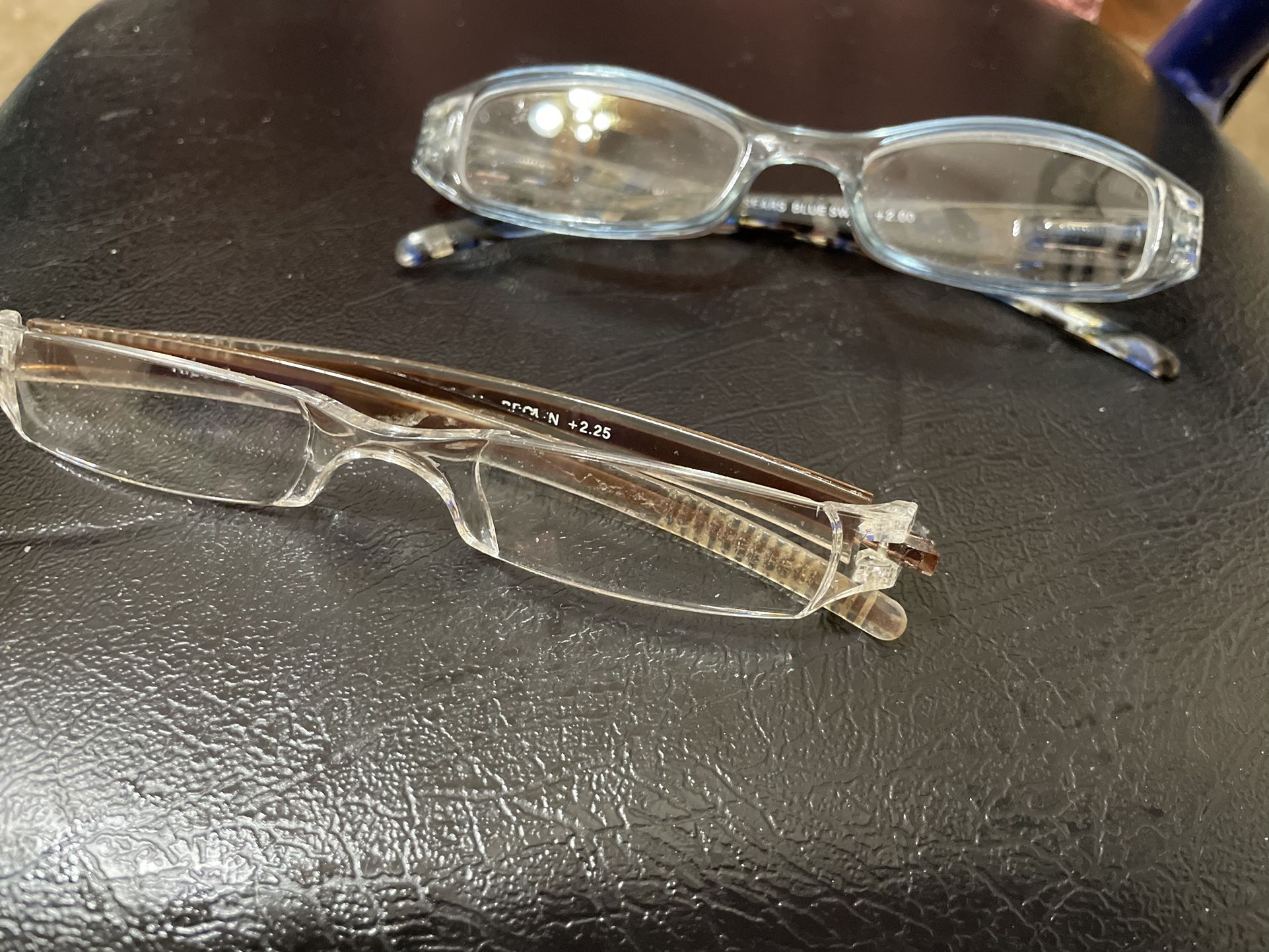Readers eye glasses one has light blue frame & one has clear frame $10.00 ea