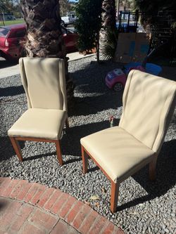 Pair of Cream Upholstered Dining Chairs with Decorative Back
