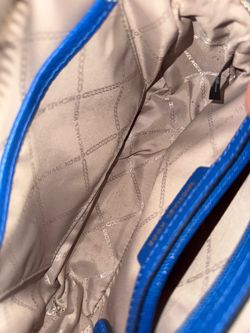 This item is a Michael Kors Studded Crossbody Handbag featured in the vibrant "Grecian Blue" shade