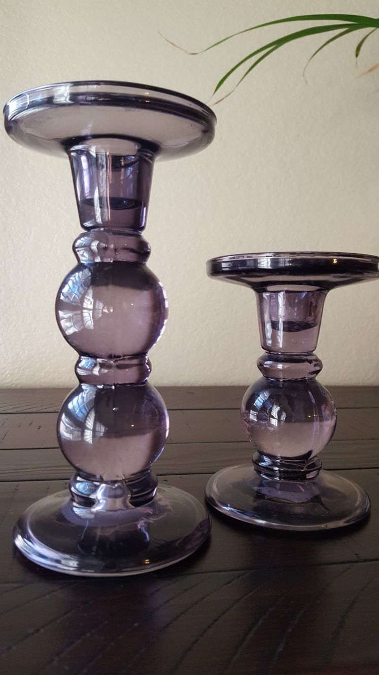 A pair of purple glass candle holders