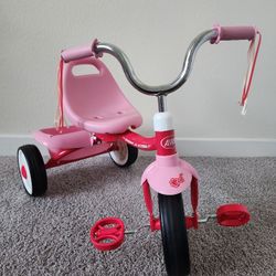 Radio Flyer Fold 2 Go Tricycle pink. The storage bin is missing the cover
