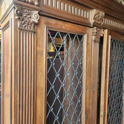 Antique Italian  bookcase hand-carved of walnut with lion paw feet