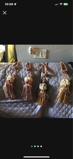 Two sets of fancy decorative tie-backs.