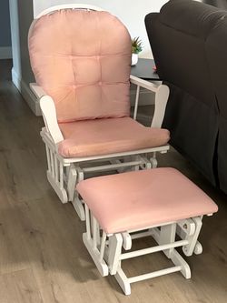 White wood nursery glider and matching ottoman set with pink cushions