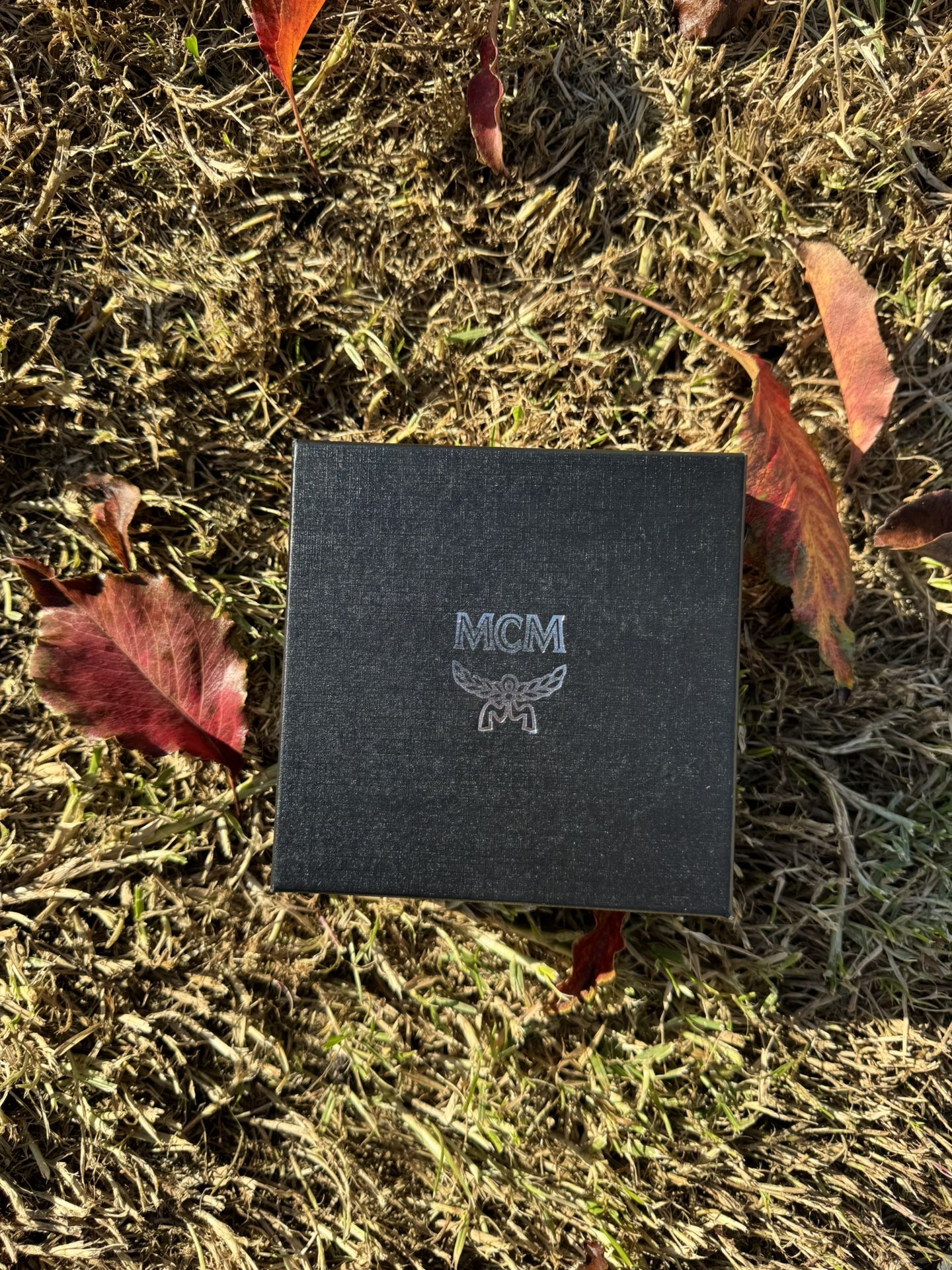 MCM Claus Reversible Leather Belt with a gold-plated M buckle.