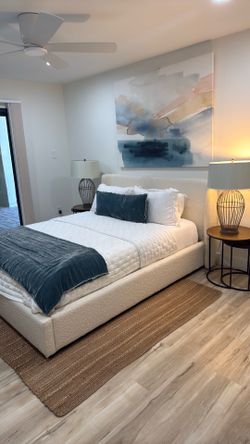 Queen bed; boucle material w/ rug and lamps
