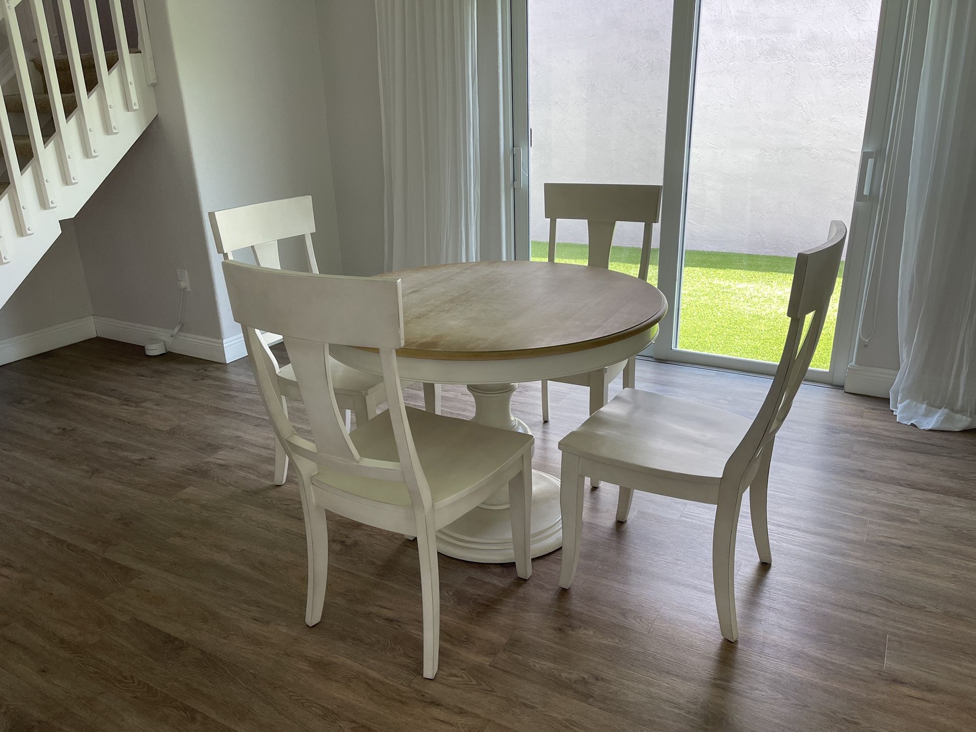 Round Wooden Pedestal Table and Four Wooden Chairs