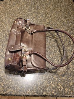 Purse brown flap purse 8x13 snake skin print on corners and buckle double straps.