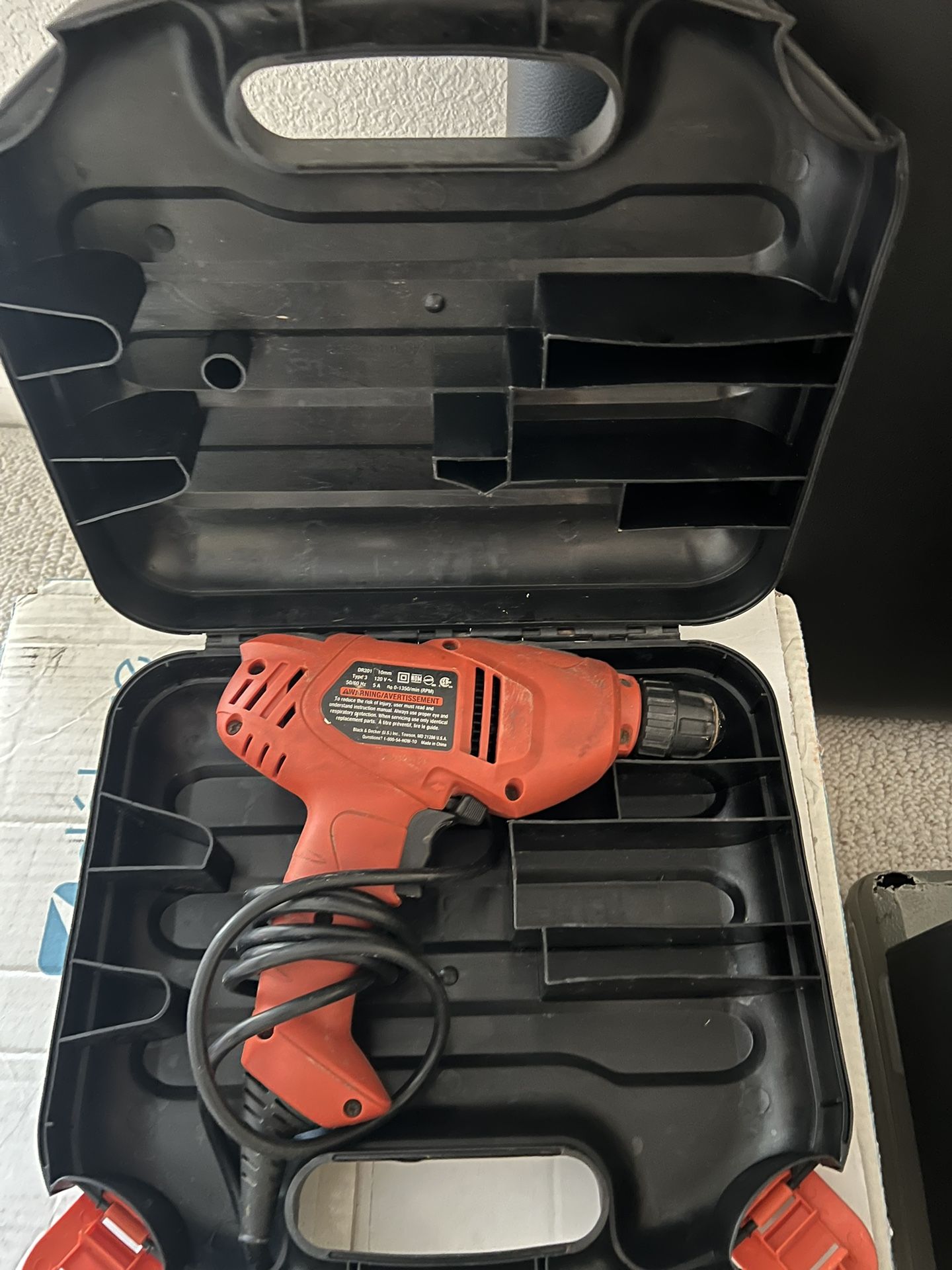 Red electric drill in carrying case.