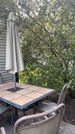 Outdoor Patio Table with Umbrella and Chairs