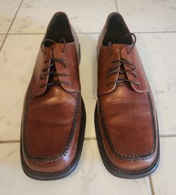 Bostonian brown leather oxford dress shoes feature a distinct square-toe moccasin design.