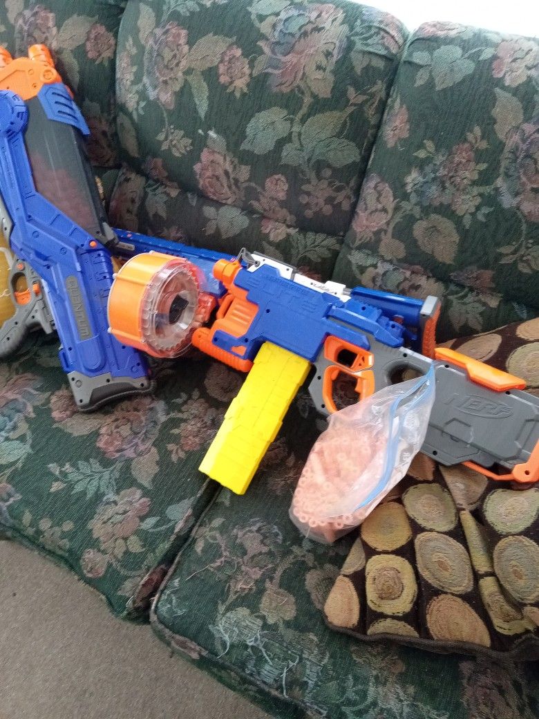 Three Nerf Guns One Shoots Little Red Balls