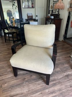 Plush dark wood beige armchair