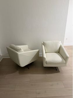 A pair of White leather 360 swivel chairs