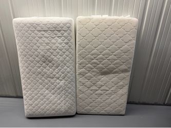 Light colored baby crib and mattress