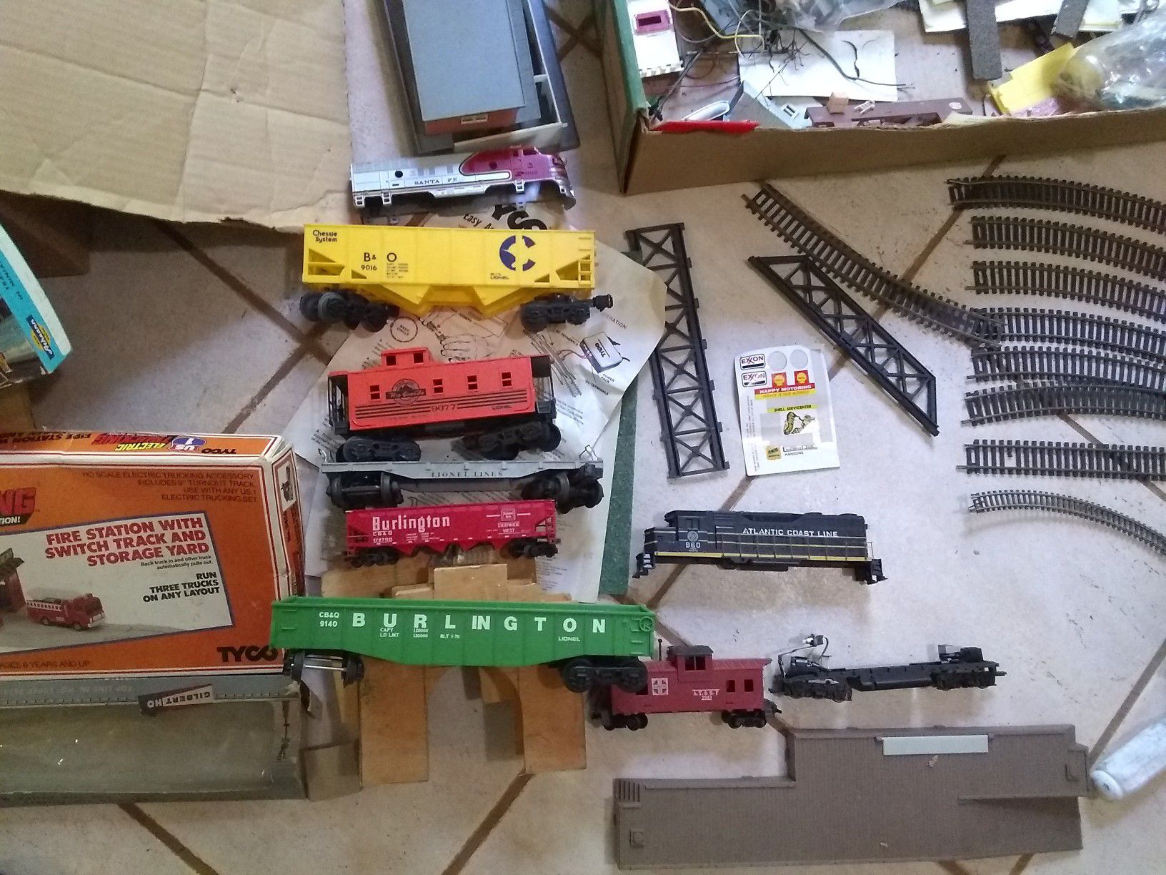 Miscellaneous toy train items, track, cars, engines, trucks and buildings