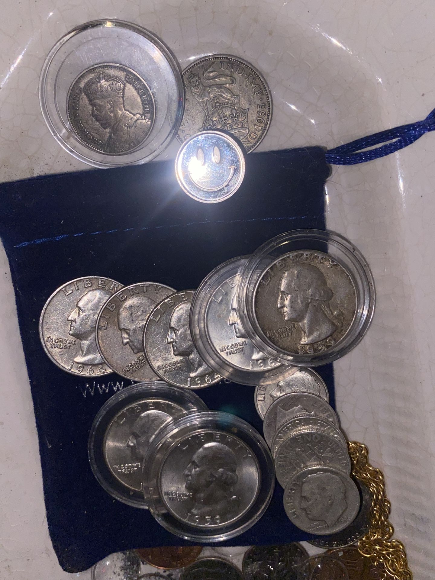 Seven individual 90% silver quarters five individual 90% percent dimes 1934 six pence New Zealand silver 1935 one shielding silver