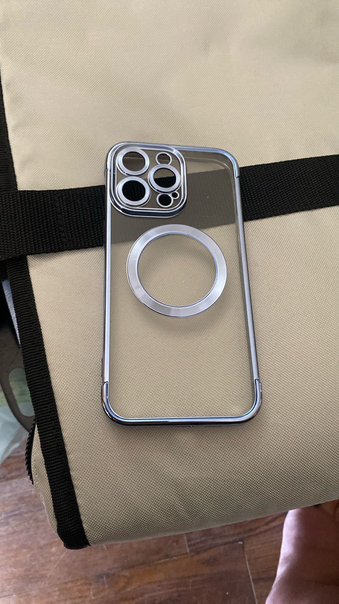a clear magnetic phone case with a chrome bumper, compatible with MagSafe wireless charging, designed for iPhone models with a large camera module lik