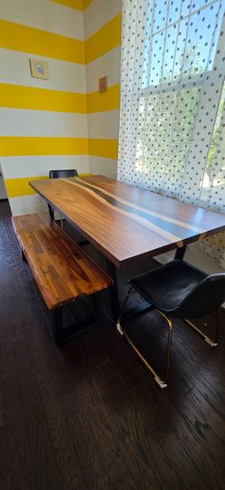 A six-seater dining table is available, accompanied by two chairs and a bench.
