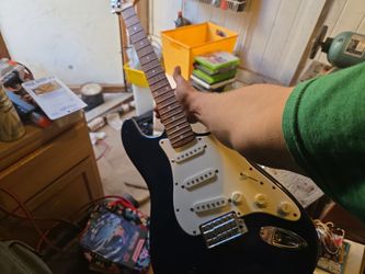 Black Stratocaster-Style Electric Guitar no strings. Seen better days