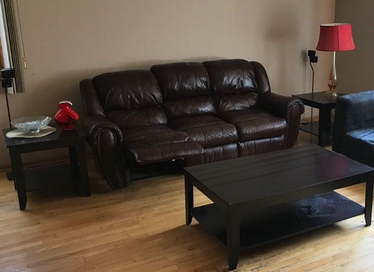 Leather sofa recliner with end table and cocktail table included.