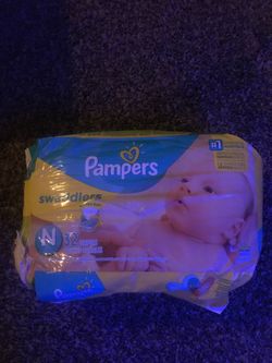 Pampers swaddles newborn