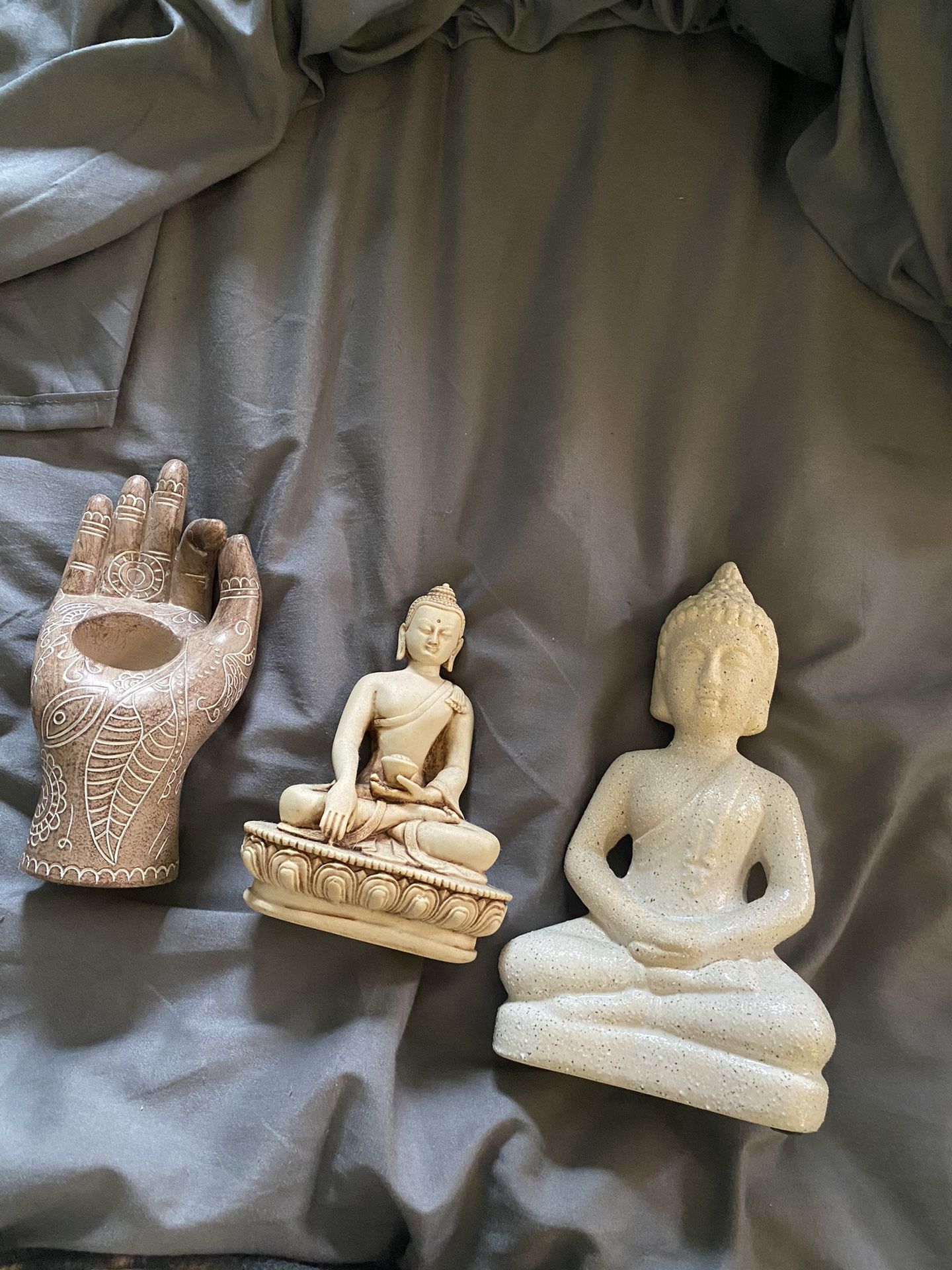 Two Buddha Statues And A Candle Holder 