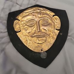 vintage museum reproduction of the Mask of Agamemnon with seal