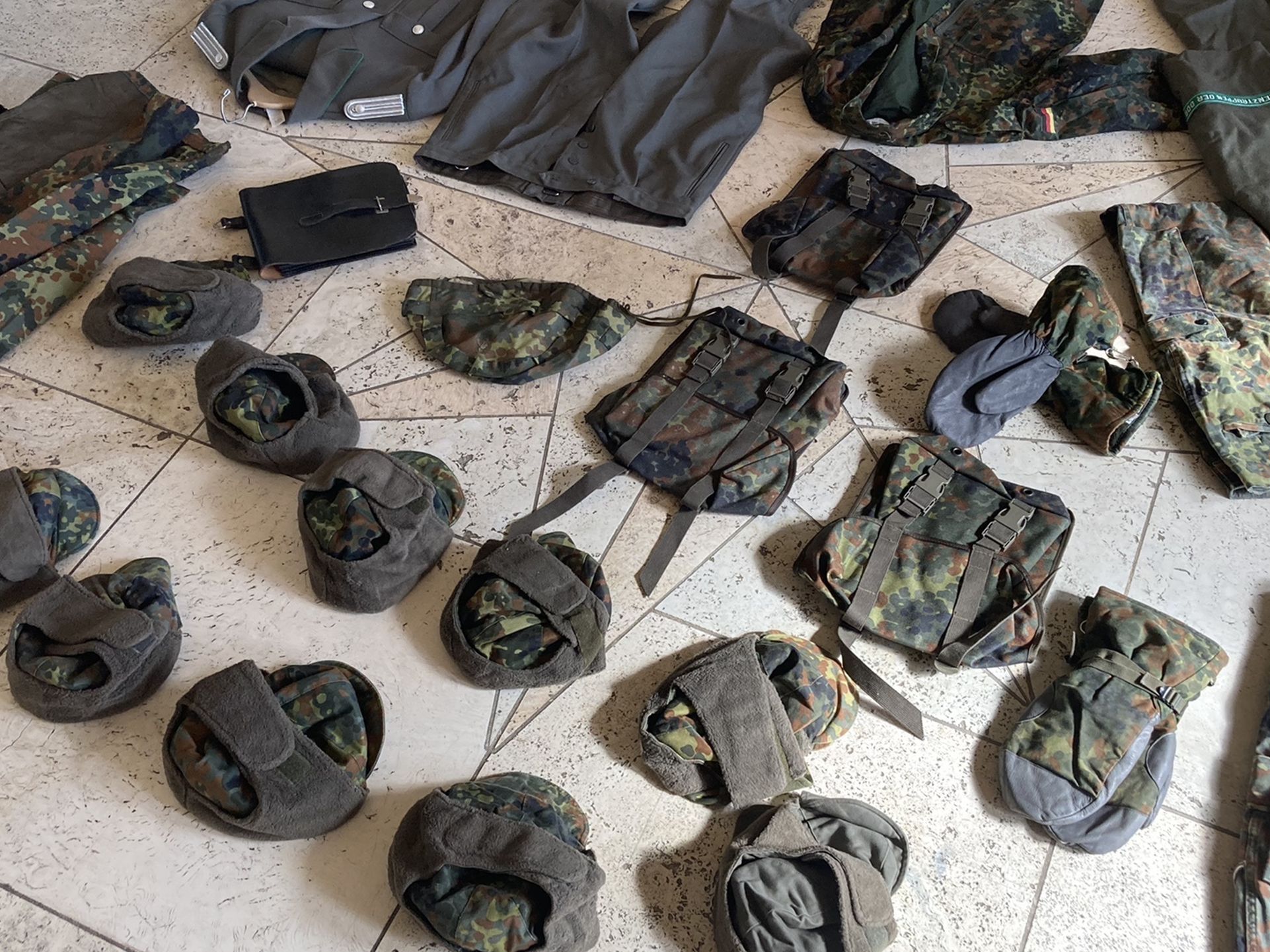 Surplus military lot of vintage East West German uniforms hats gear 1980s 90s overcoat jacket man cave