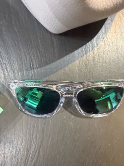 Oakleys with Clear Frame and Green Mirror Lenses