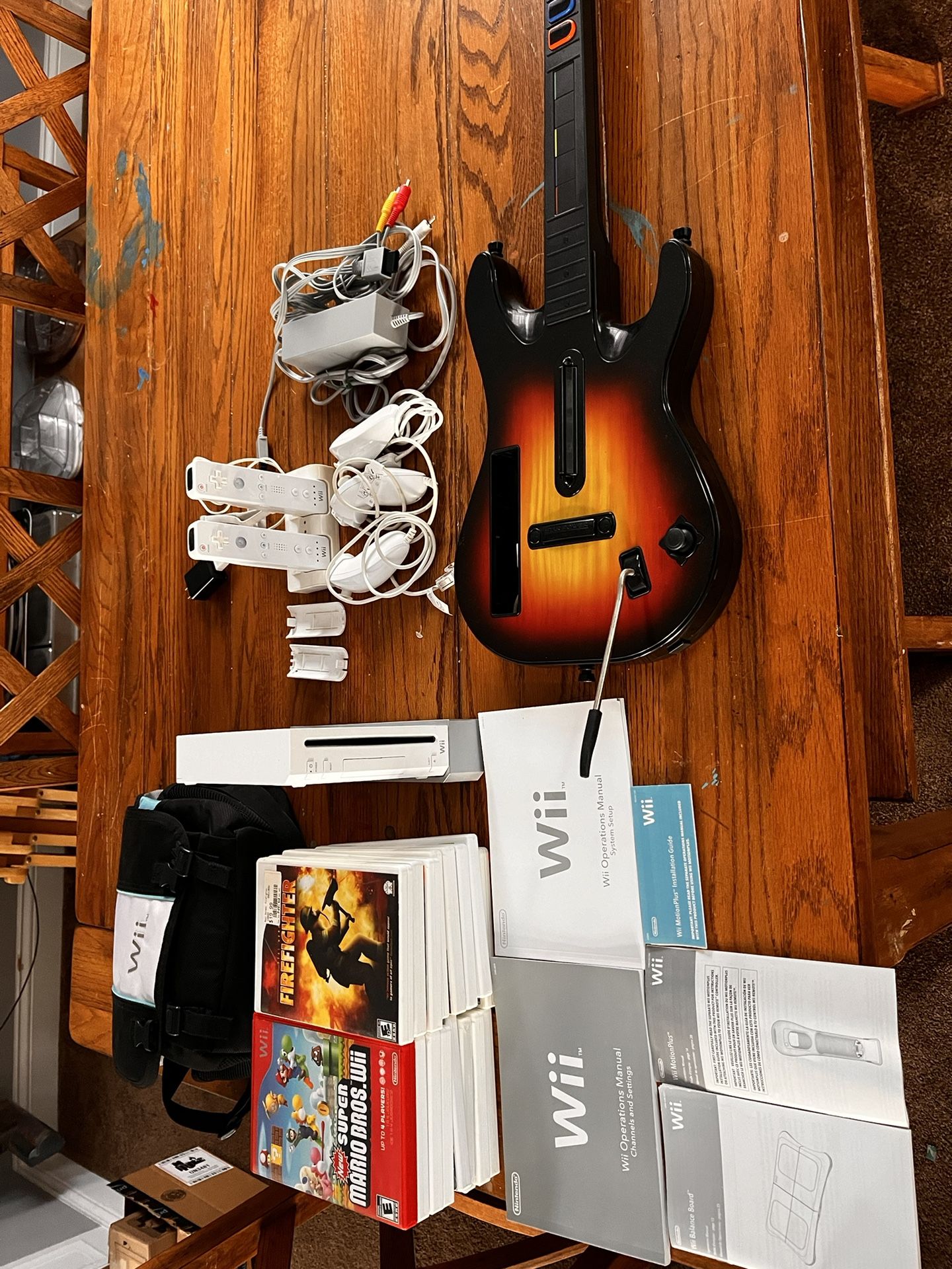 Nintendo Wii w/16 games, WiiFit Balance Board and Guitar. 200obo