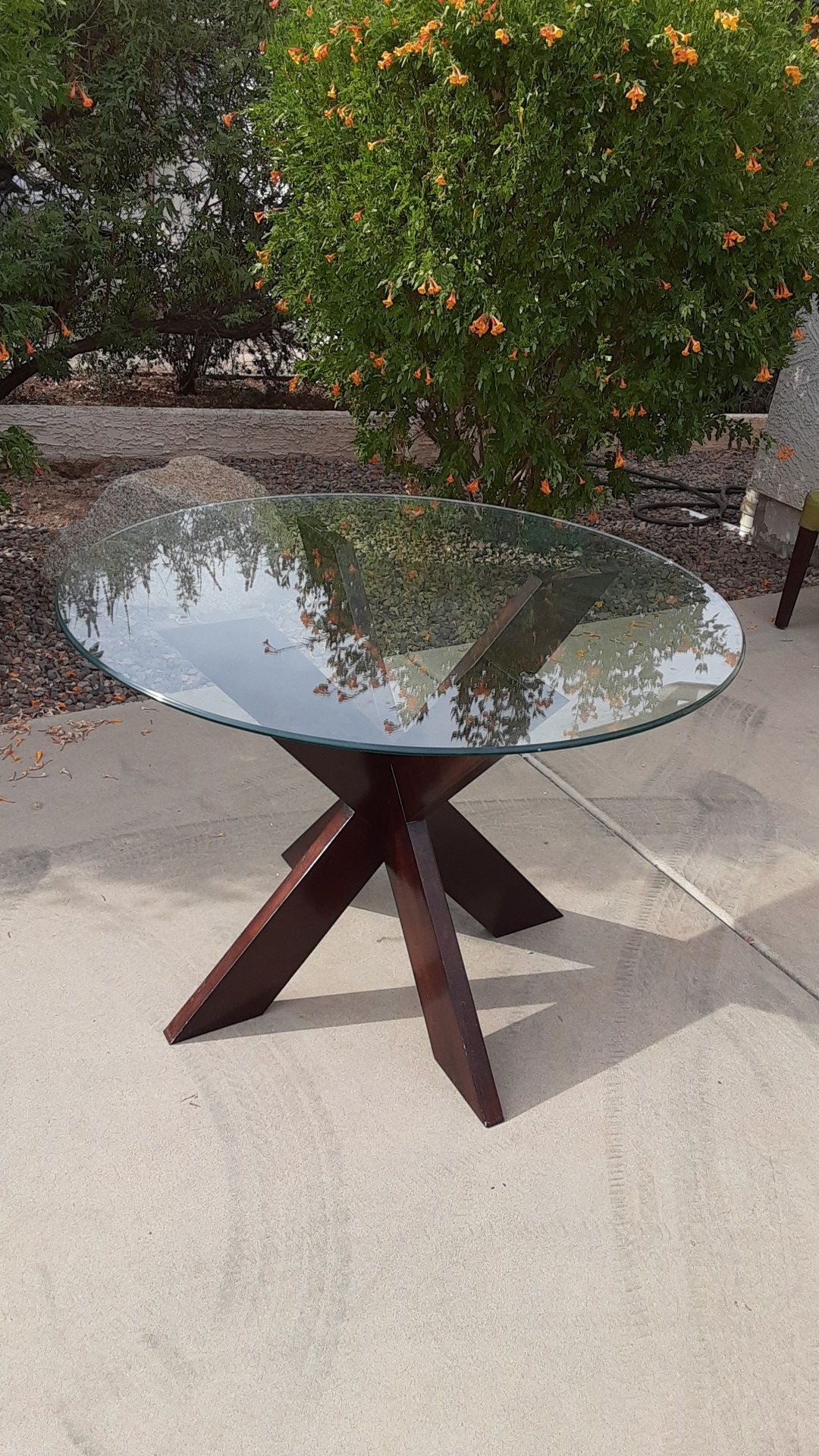 Small glass kitchen table with dark brown wooden pedestal. 42 inches in diameter. In great shape. 30 inches in height.