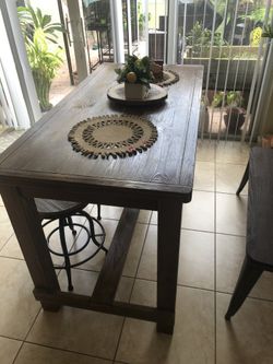 Wooden table with two stools