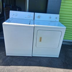 Pair of Kenmore brand washing machines, gas-powered, and dryers are in good condition.