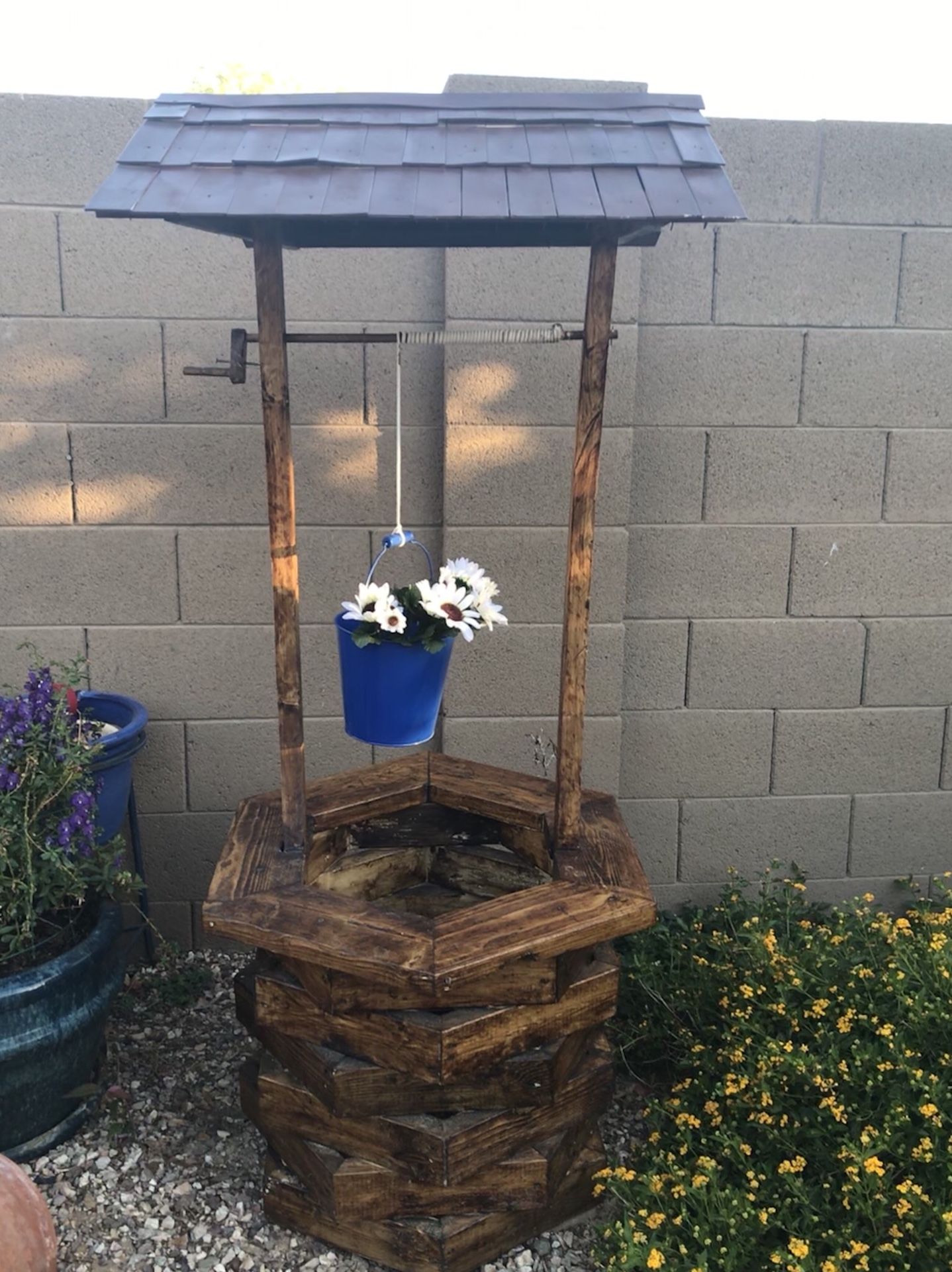 Handmade Wishing Well Planters .We have 4 different sizes and several different styles.Priced At $50.00-$150.00