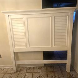 white wooden headboard featuring louvered shutter side panels in a classic coastal style.