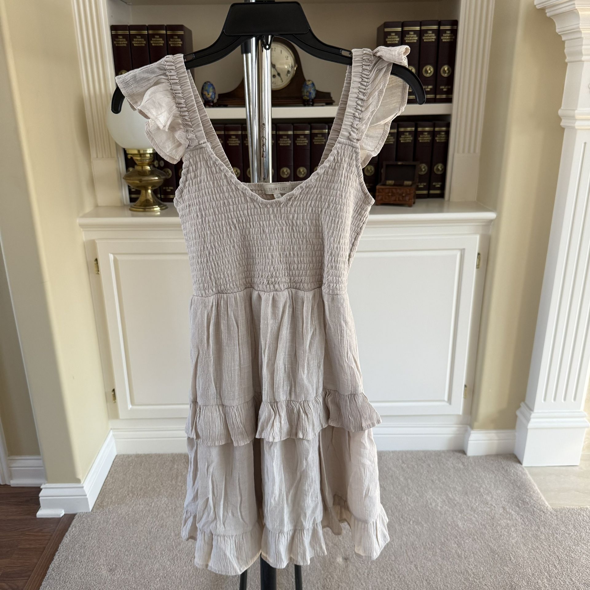 Ultra Flirt Kid's beige smocked ruffle mini dress with layered tiers and ruffle sleeve