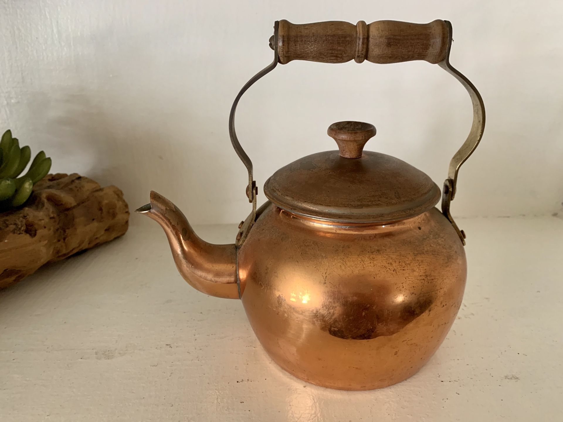 Antique copper tea kettle with wood handle