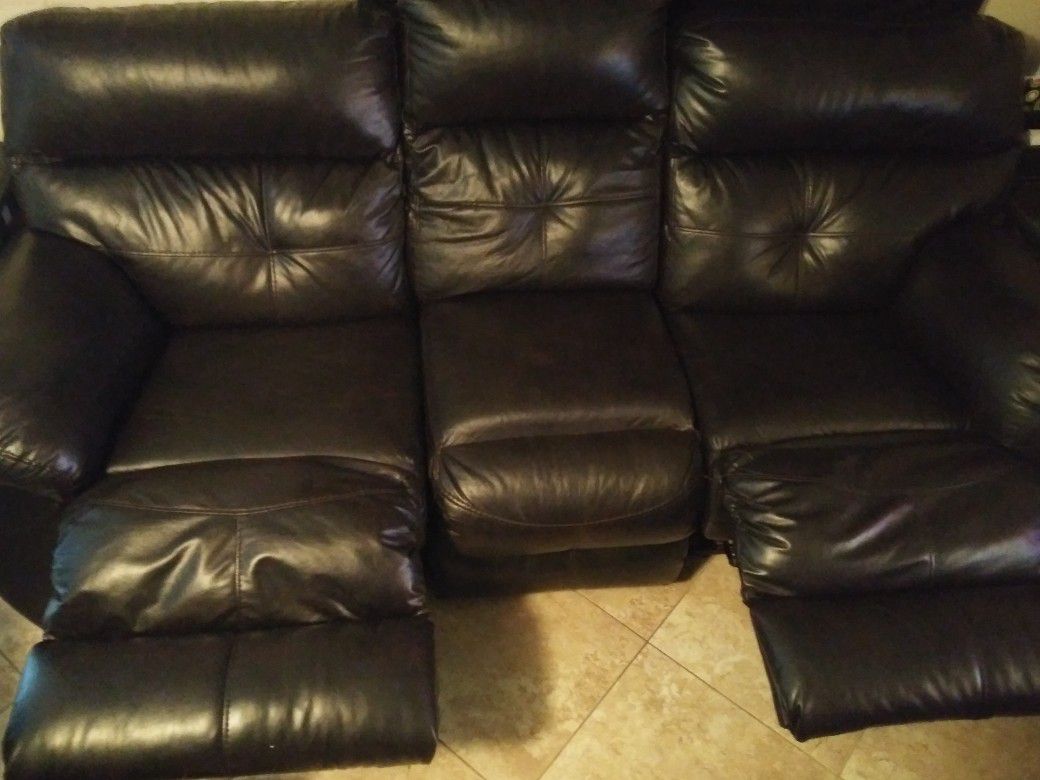 Dark brown couch, it looks black with 2 recliners