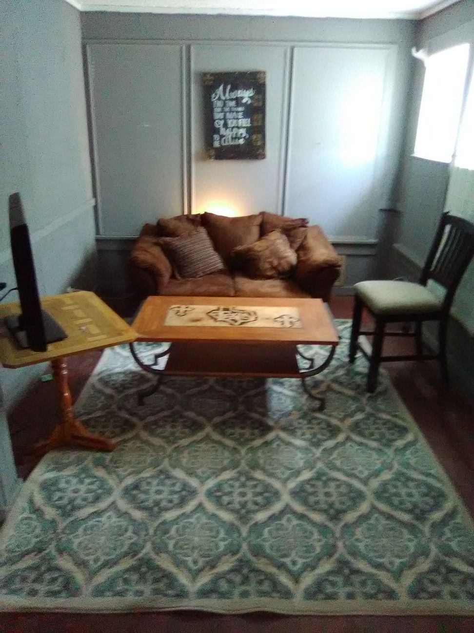 Couch, rug, hand painted signs and coffee table