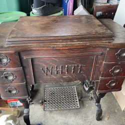 Antique white treadle sewing machine