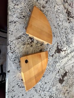 2 light brown, wedge-shaped wooden corner shelves
