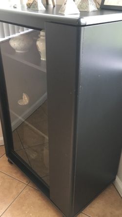 Entertainment center H 41" x W27" x D16" has 3 shelves with glass door.