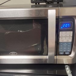 Oster Stainless Steel  11 00 Watt Microwave Like New 