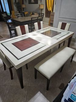 Dining room table with four chairs and bench